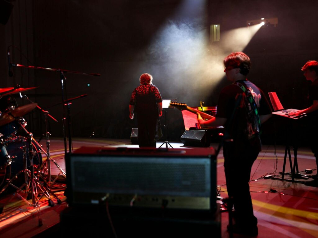 Charlee on stage with light filtering through